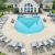 a pool surrounded by lawn chairs