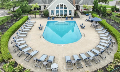 a pool surrounded by lawn chairs